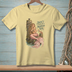 Light yellow t-shirt with mermaid and crab graphic saying "Don't touch the mermaid hair."