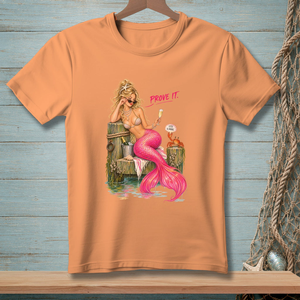 Peach t-shirt graphic of a mermaid sitting with a glass of champagne and a crab.