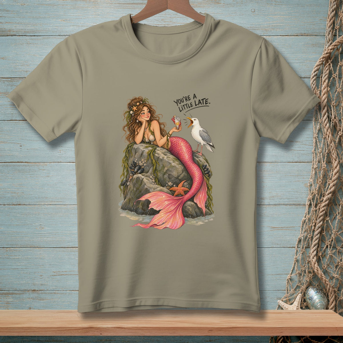 Mermaid on rocks with a seagull and text "You're a little late."