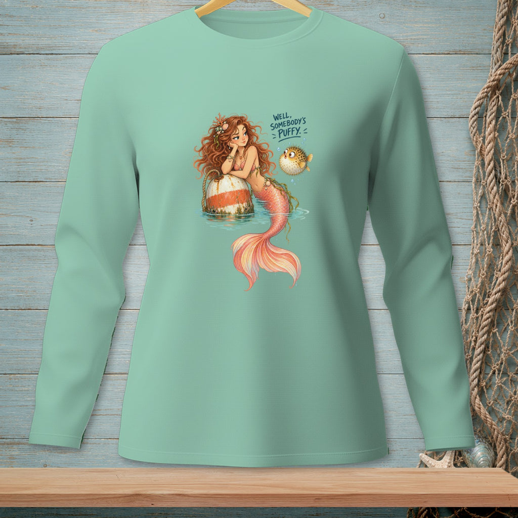 Long-sleeve shirt with mermaid resting on buoy and puff fish with text.