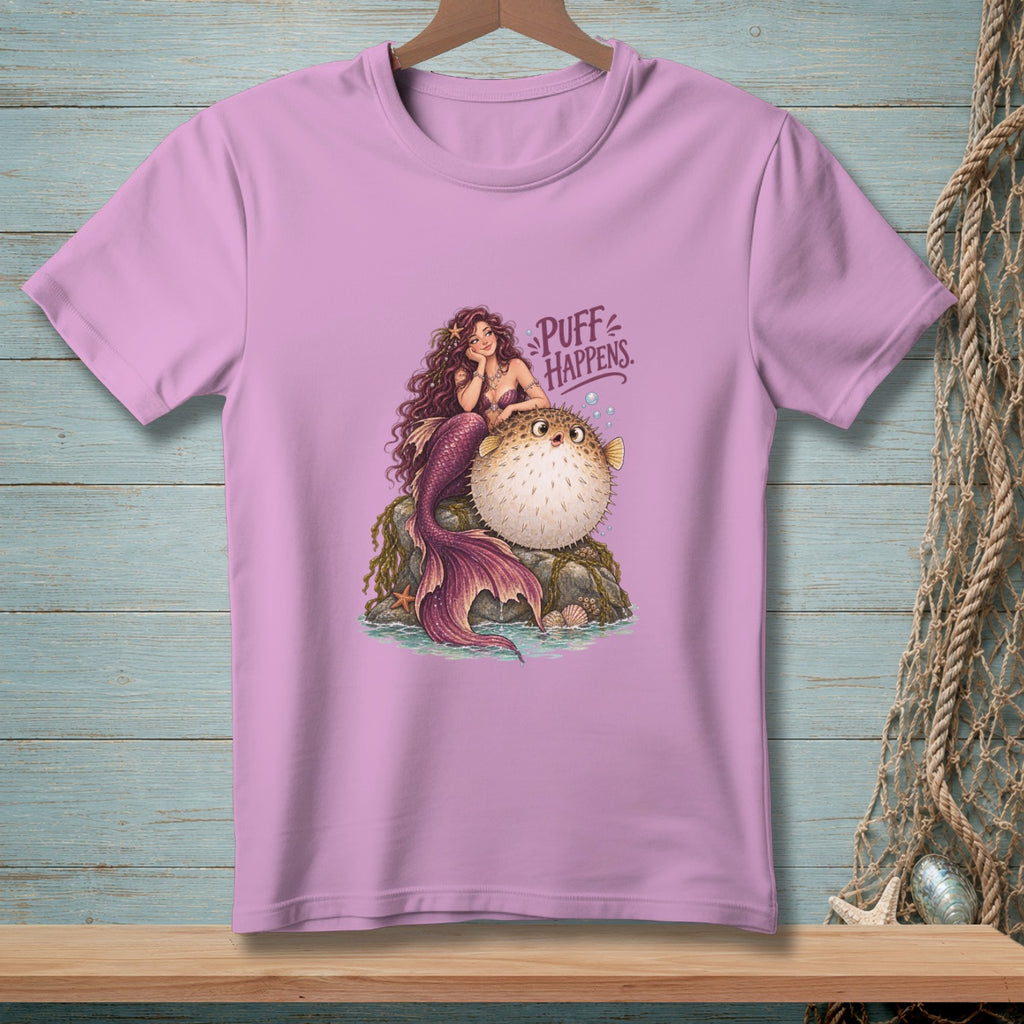 Mermaid and pufferfish with text "Puff Happens" on a lavender t-shirt.