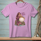 Mermaid and pufferfish with text "Puff Happens" on a lavender t-shirt.