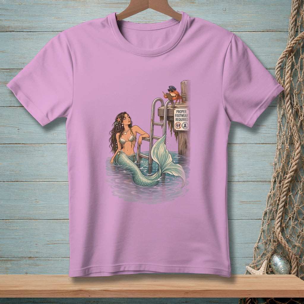 Mermaid lounging by a ladder with a crab on a post that reads "Proper Footwear Required".