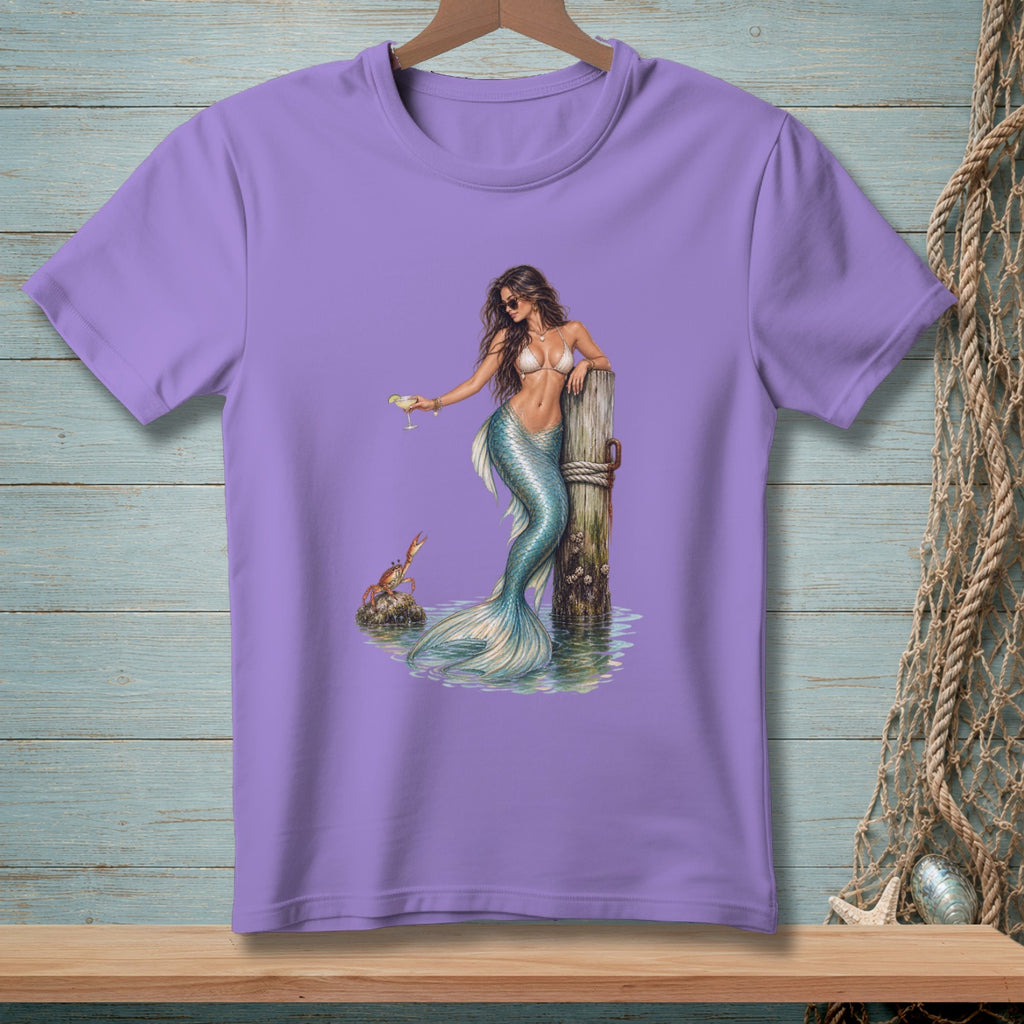 Purple t-shirt with a mermaid holding a drink by a dock, with a crab nearby.