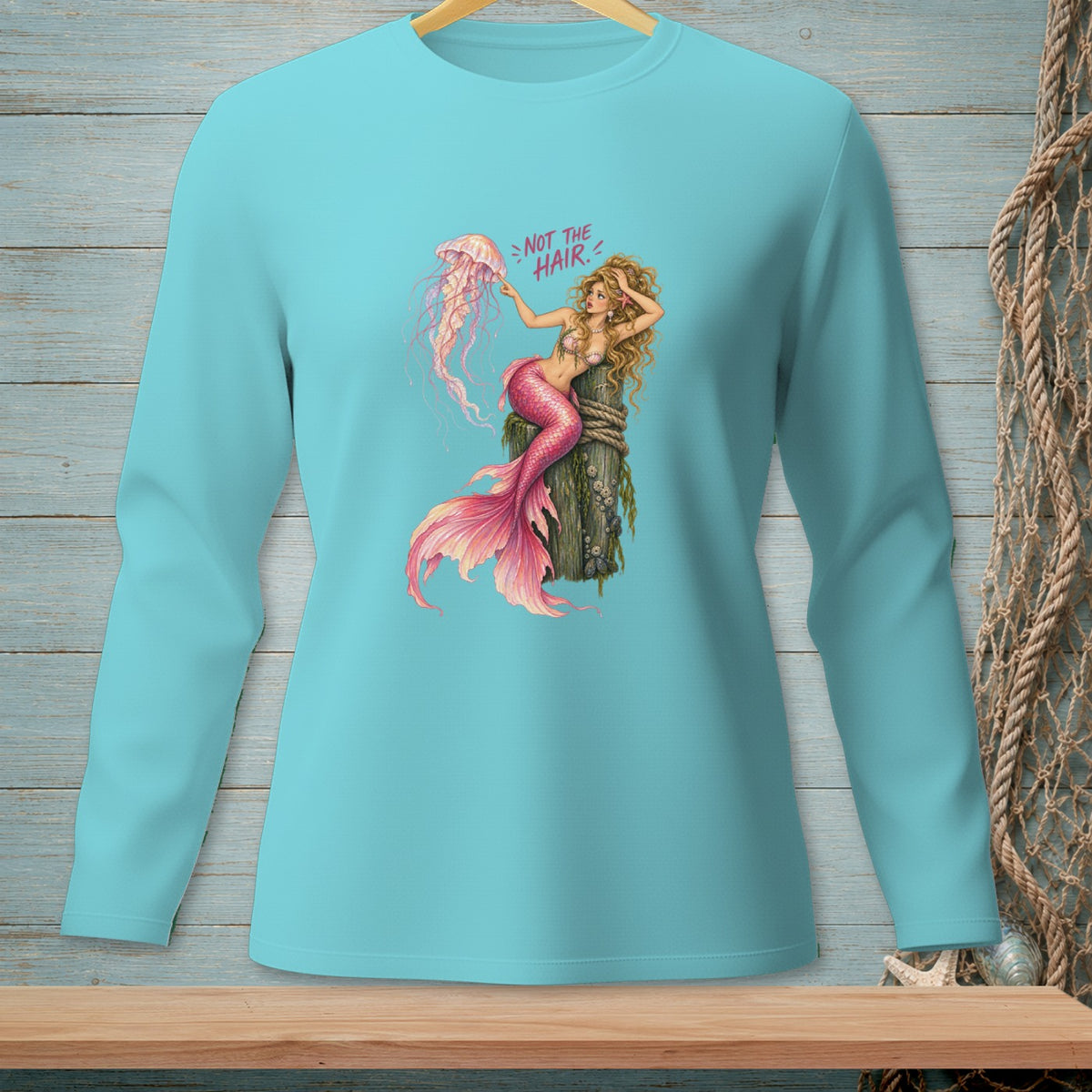 Mermaid touching jellyfish, text "Not the Hair", on a light blue long-sleeve shirt.