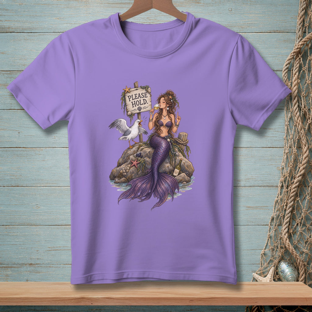 Mermaid sitting on rock by sign saying "PLEASE HOLD", with a seagull and bottle.