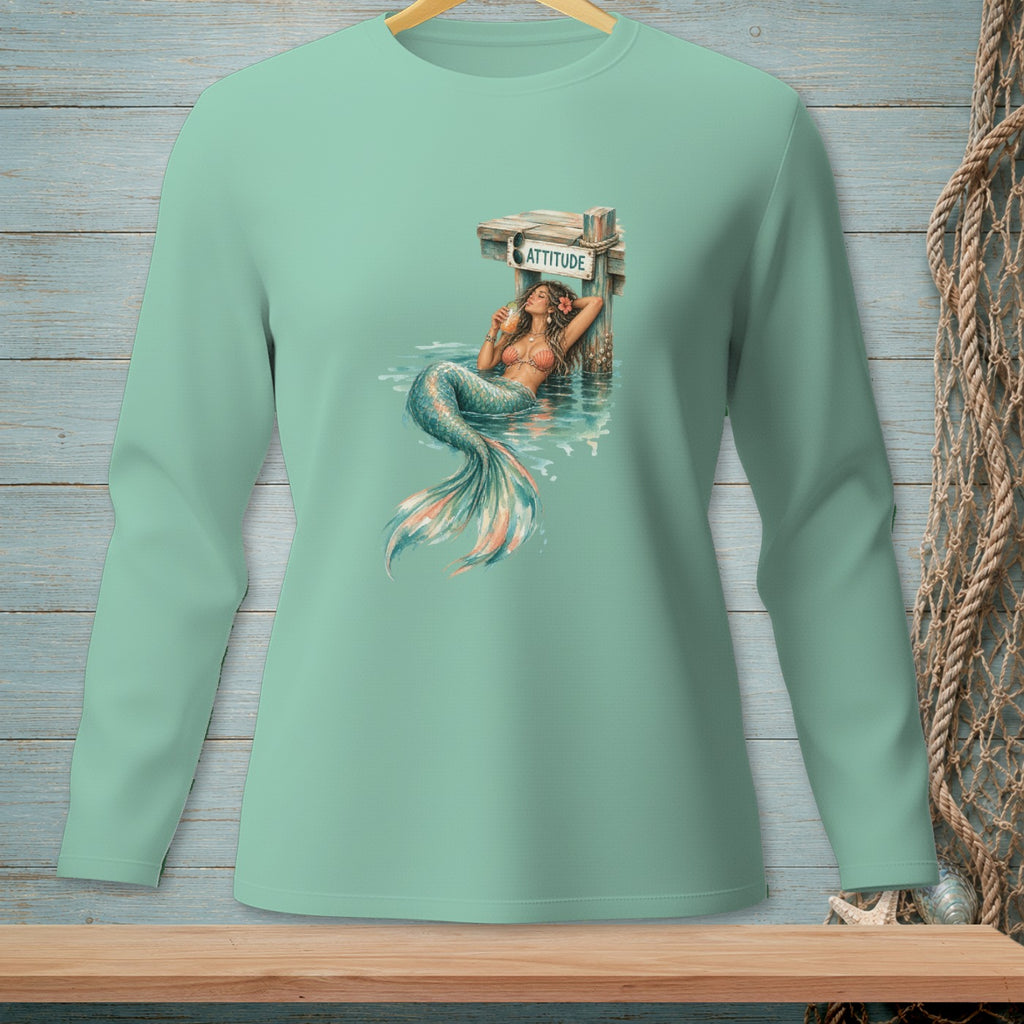 Mermaid lounging by a dock with sign that reads ATTITUDE.