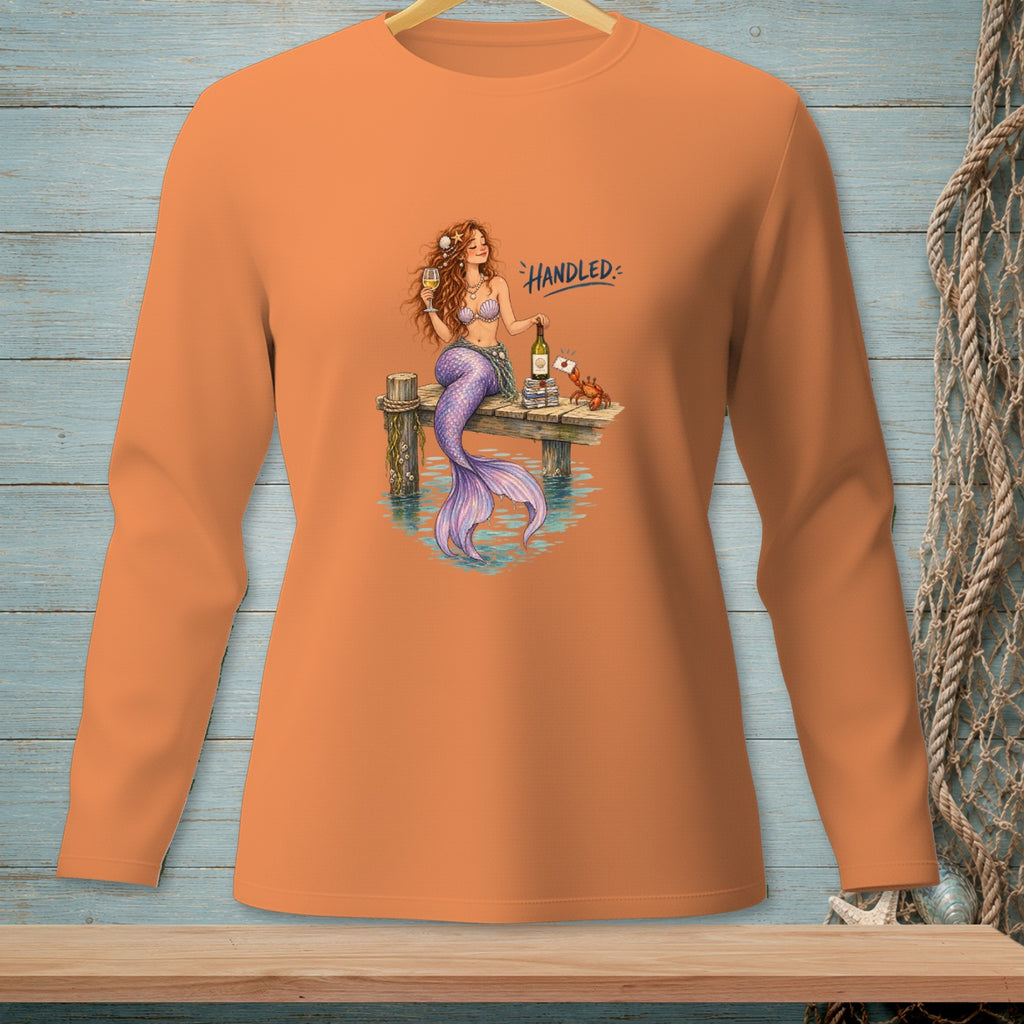 Mermaid with wine and crab on dock, with text "HANDLED".