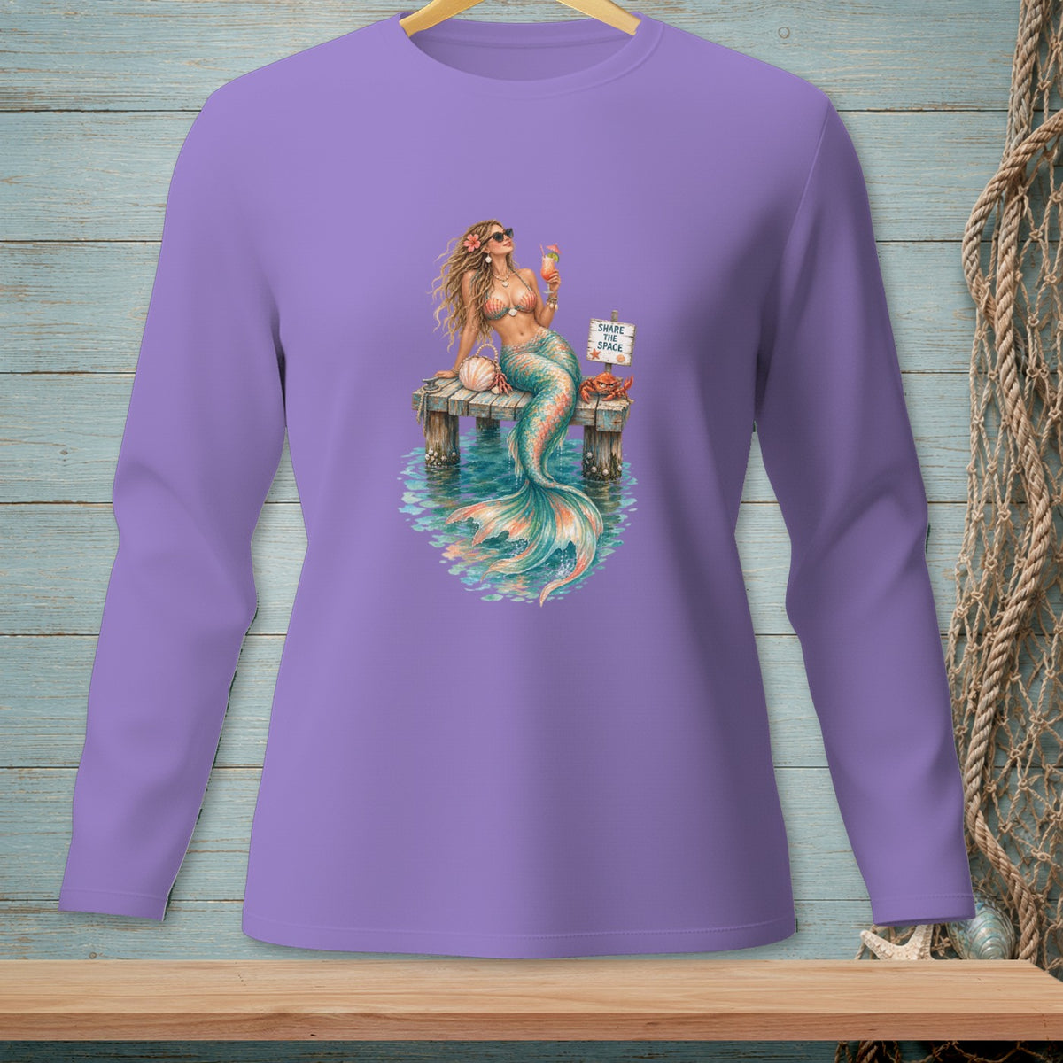 Purple long-sleeve shirt with a mermaid holding a drink on a dock.