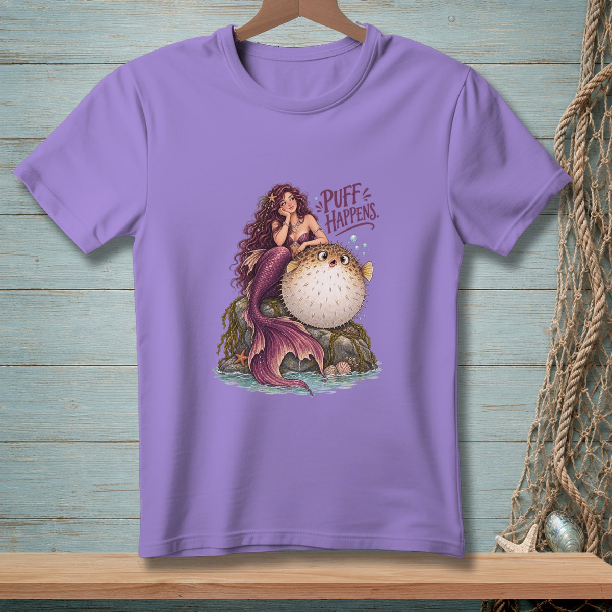 Mermaid with pufferfish and text "Puff Happens" on a purple t-shirt.