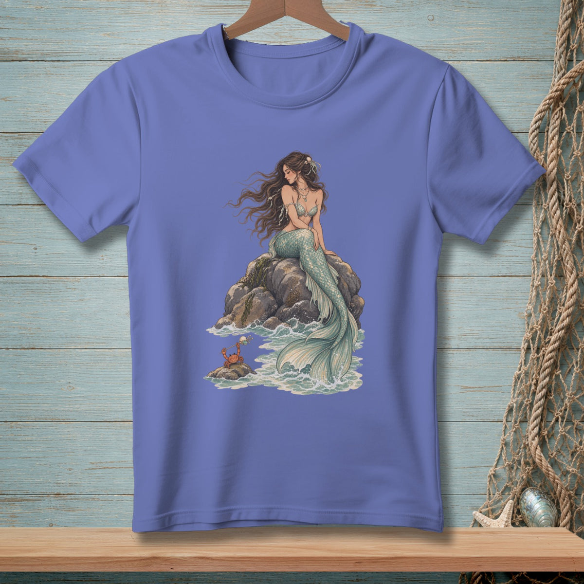 T-shirt with a mermaid sitting on rocks and a crab nearby.