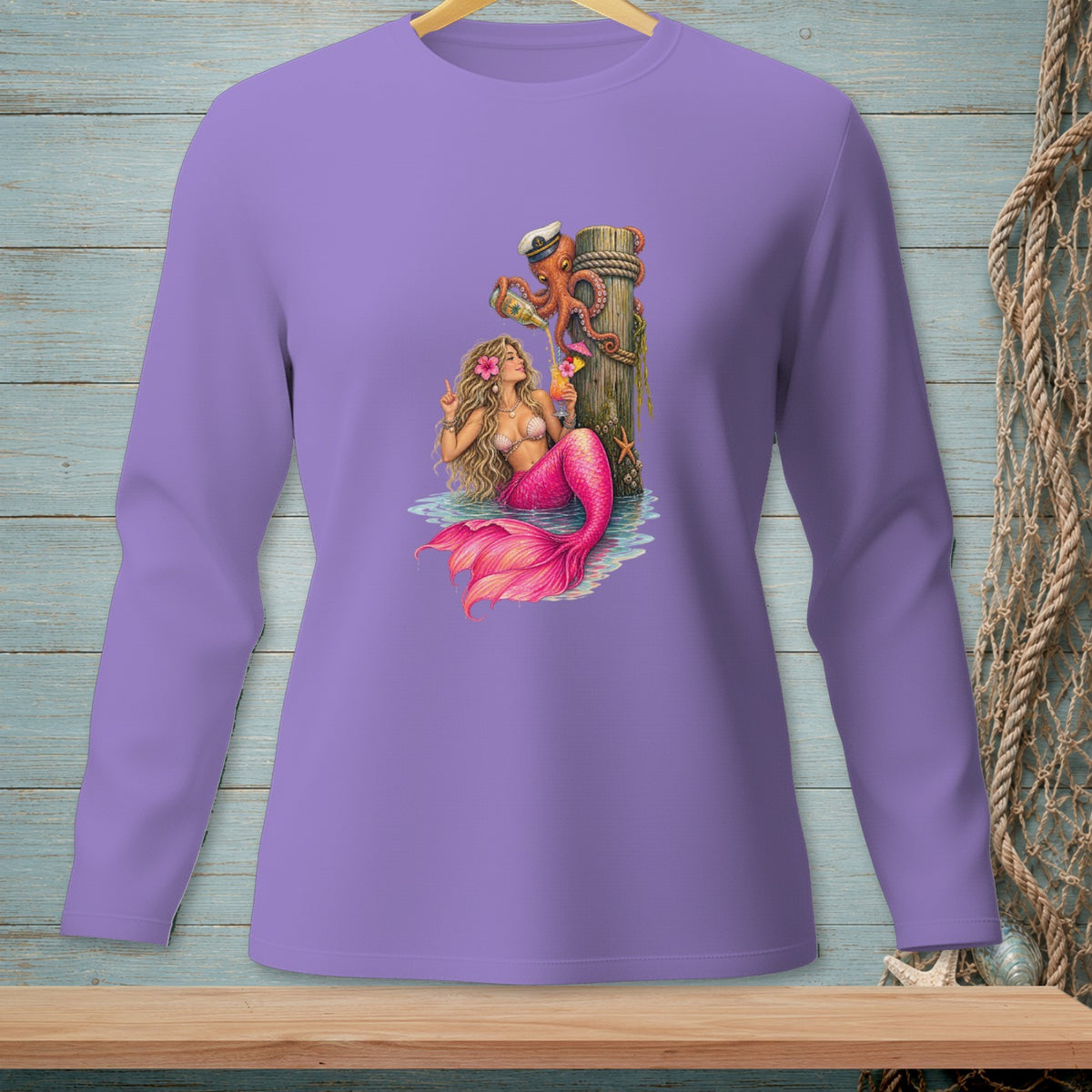 Purple long-sleeve shirt with mermaid, octopus, and tropical drinks graphic.