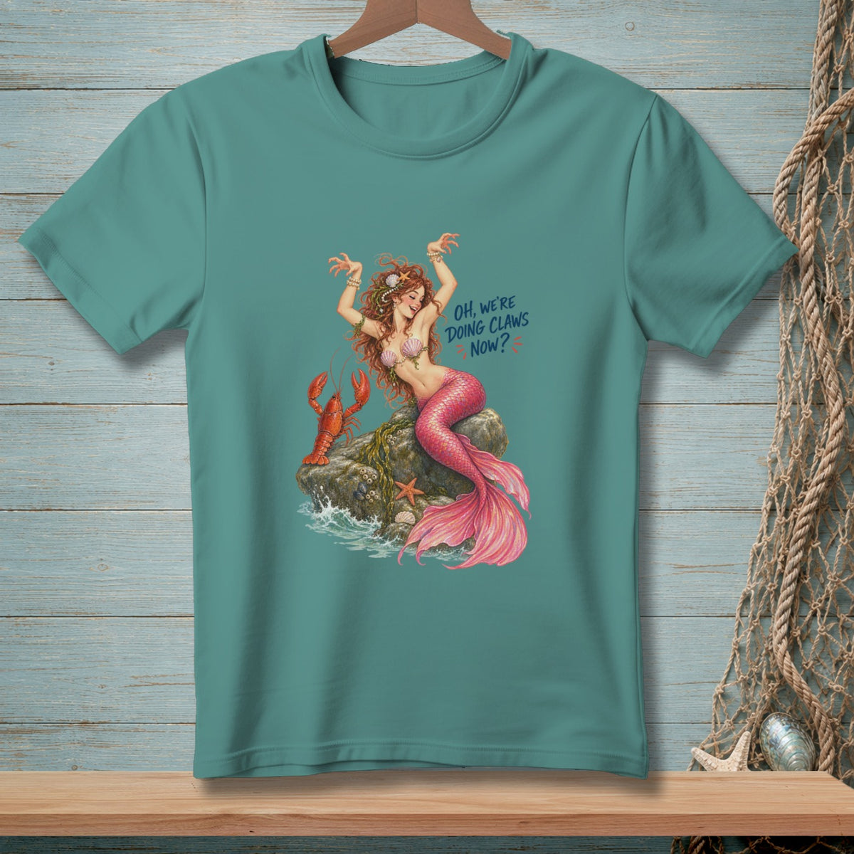 Mermaid with lobster on rock, text "Oh, We're Doing Claws Now?"