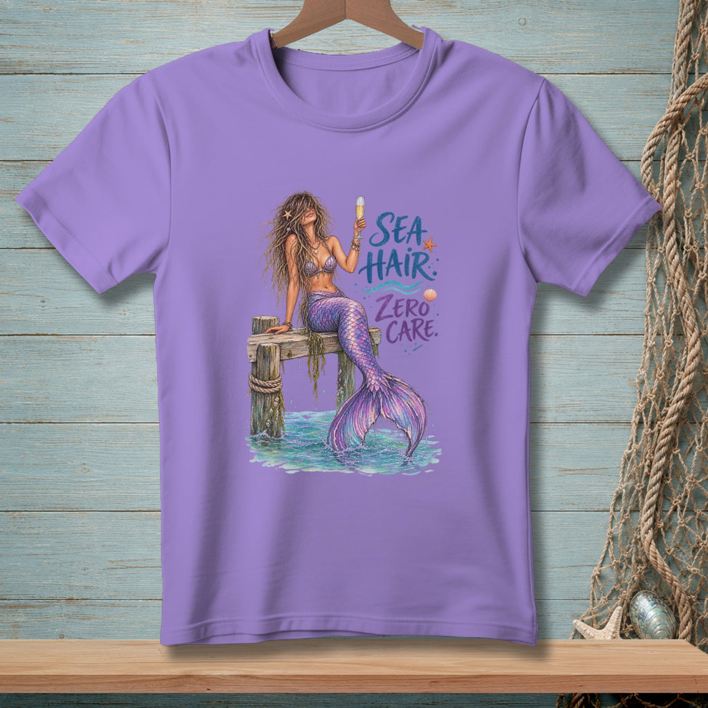 Purple t-shirt with a mermaid design and text "Sea Hair Zero Care".