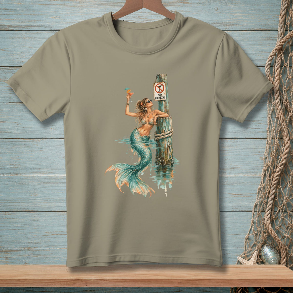 T-shirt graphic of a mermaid with a cocktail and a "No Drinking" sign.