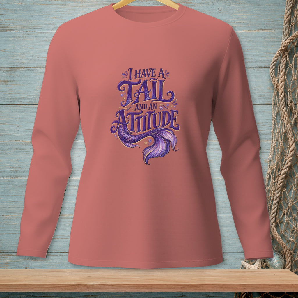 Coral long-sleeved shirt with purple text and mermaid tail graphic reading "I have a tail and an attitude."