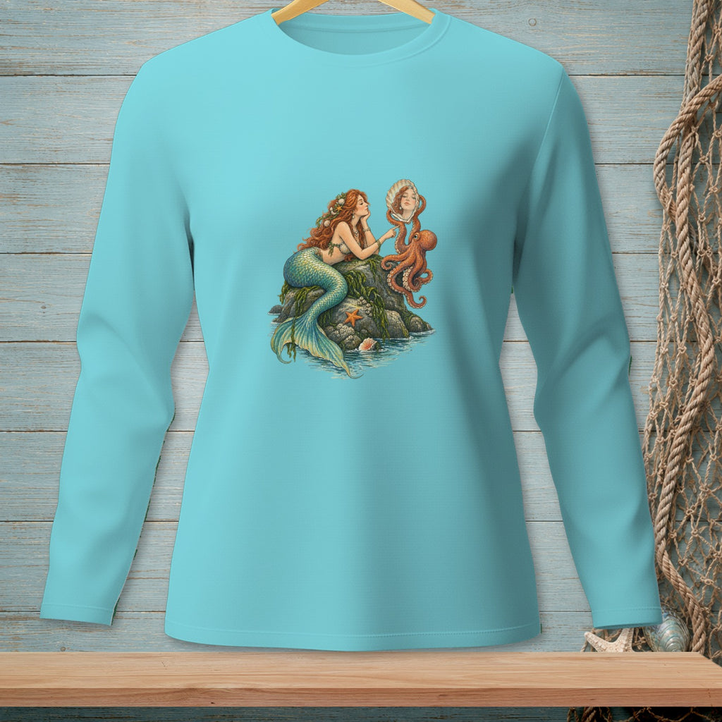 Turquoise long-sleeve shirt with mermaid, octopus, and shell graphic on rock.