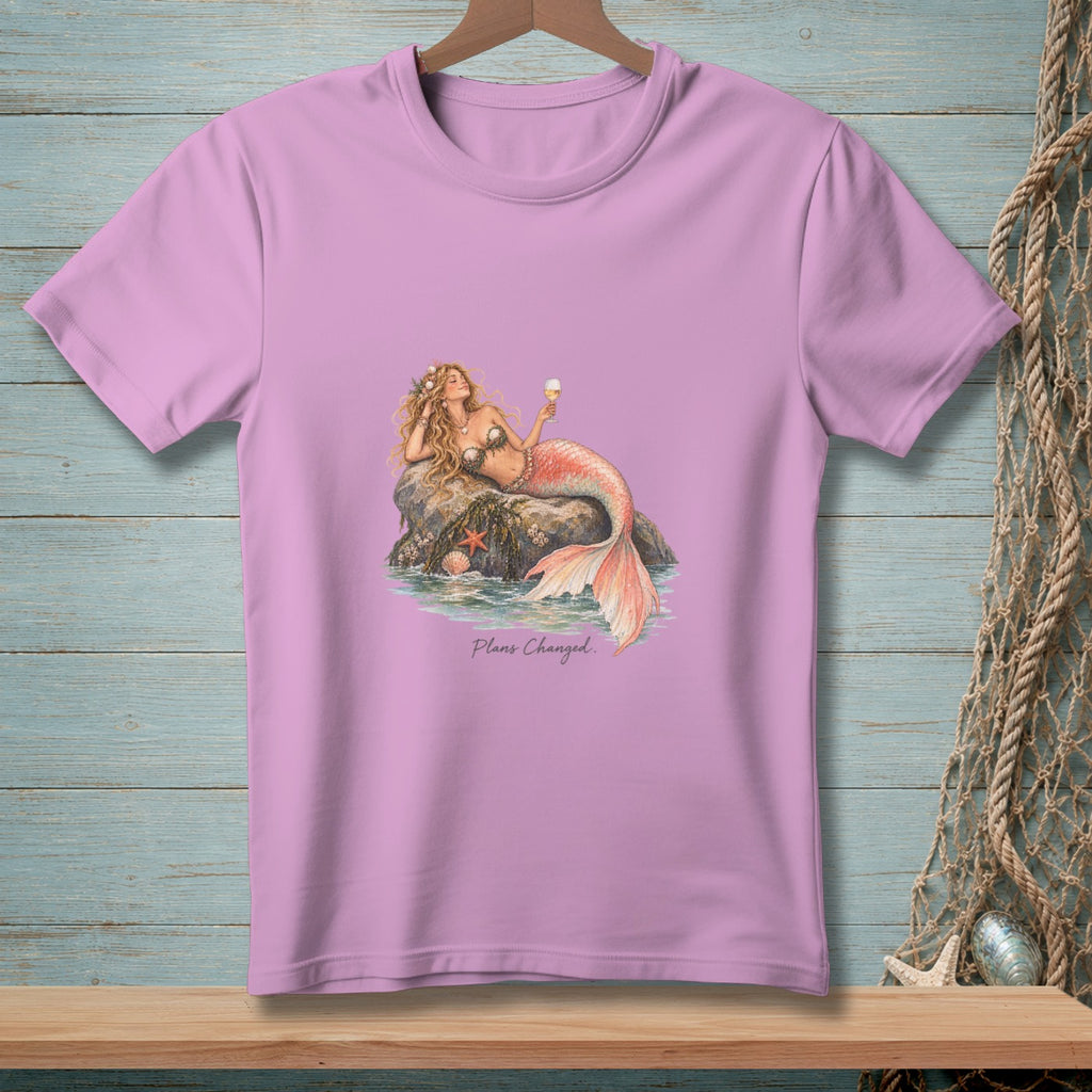 Lavender t-shirt with a mermaid resting on a rock, holding a drink. Text says "Plans Changed."