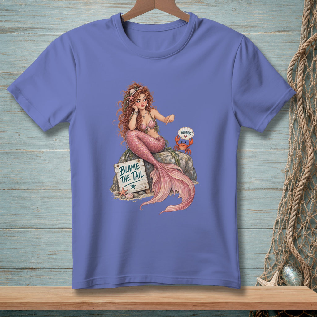 Mermaid on rock with crab, sign says "Blame the Tail", shirt graphic.
