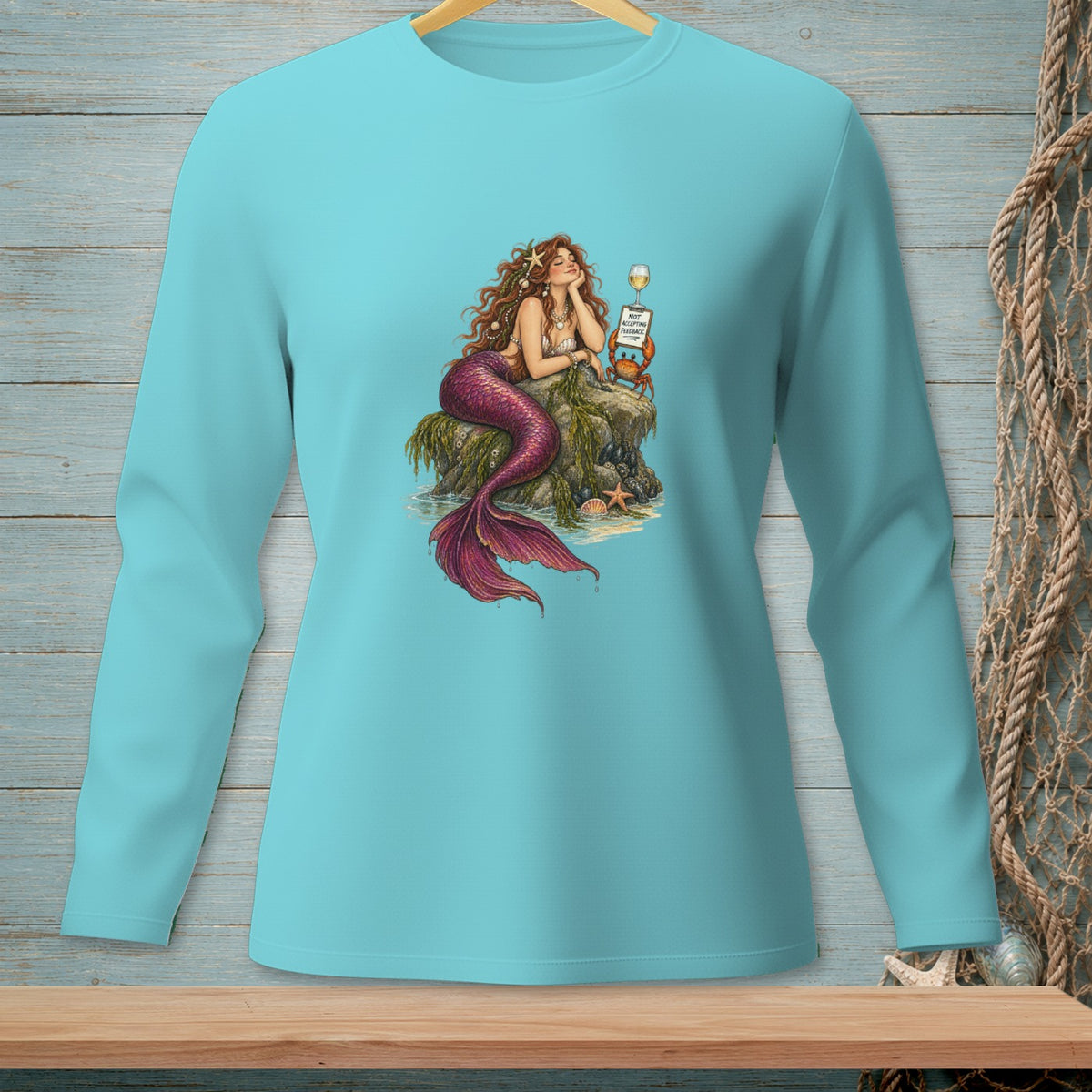 Mermaid on rock with wine, crab, and sign saying "NOT ACCEPTING FEEDBACK."