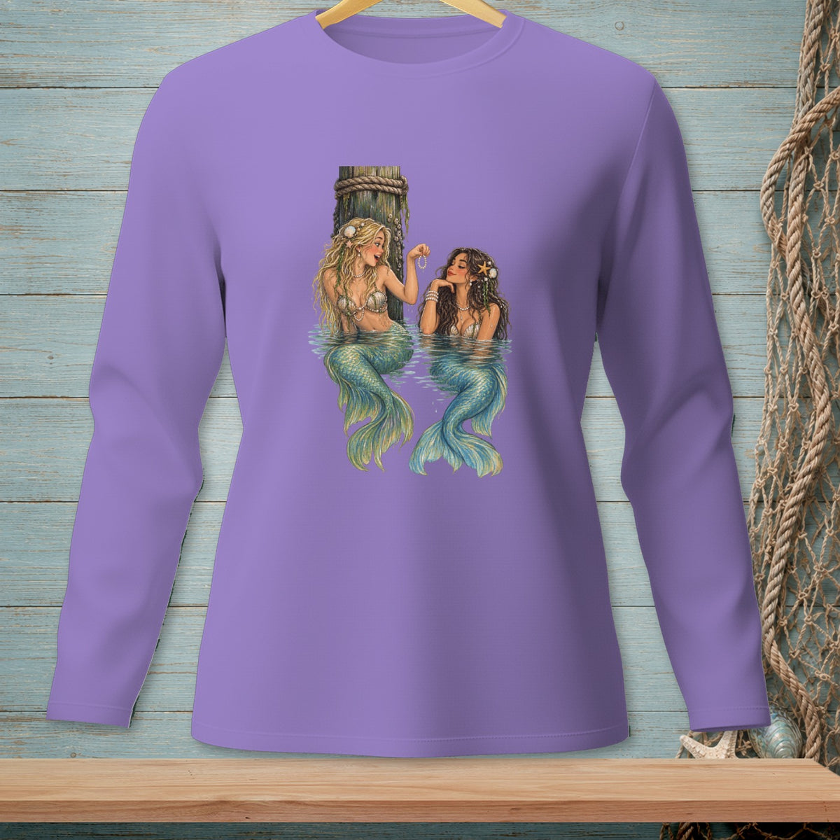 Two mermaids with iridescent tails sit by a wooden post in the water.