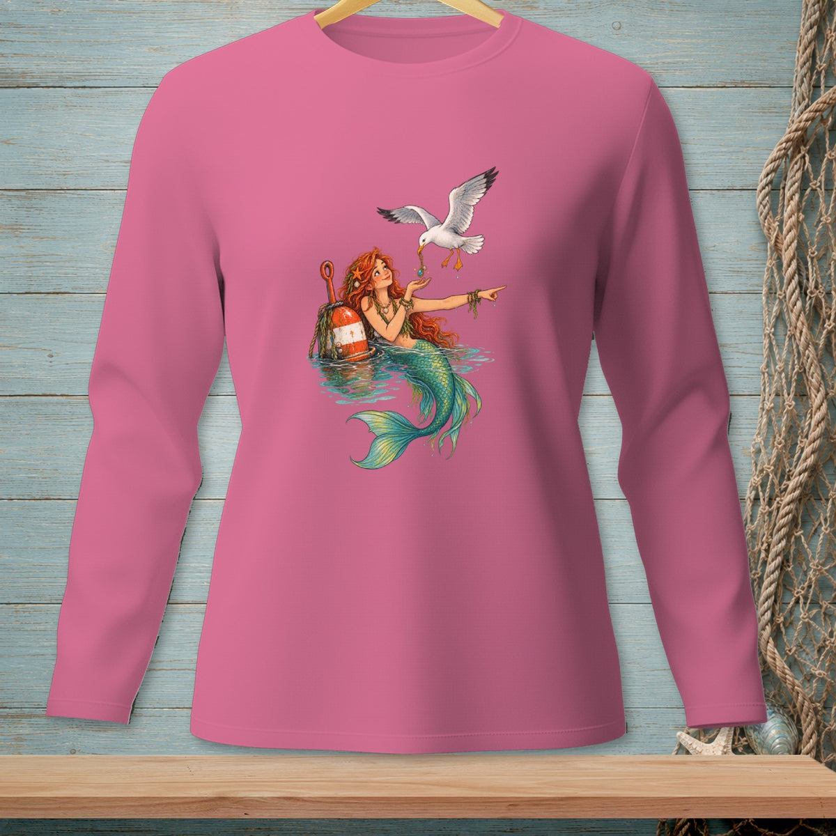 Pink long-sleeve shirt with a mermaid and seagull illustration.