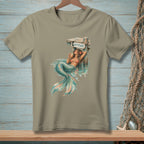 Mermaid relaxing by a dock with "ATTITUDE" sign, holding a drink.