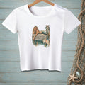White t-shirt with a graphic of a mermaid on a dock, reading "Whatever Floats Your Boat."