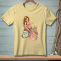 Mermaid with pink tail and crab sits on rock with "Blame the Tail" sign.