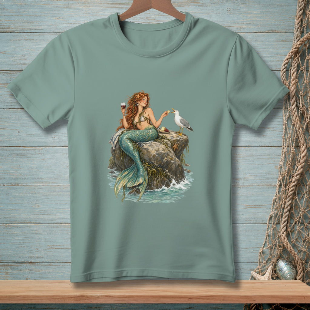 Mermaid with red hair sitting on a rock with wine and food, feeding a seagull.