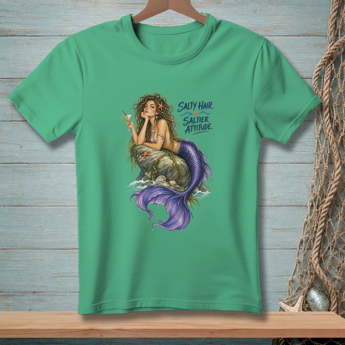 Green t-shirt with a mermaid illustration and text "Salty Hair. Saltier Attitude."