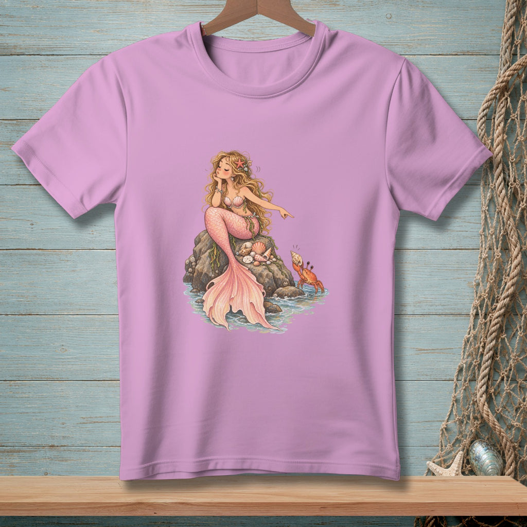 Pink t-shirt with illustration of a blonde mermaid sitting on rocks with a crab nearby.