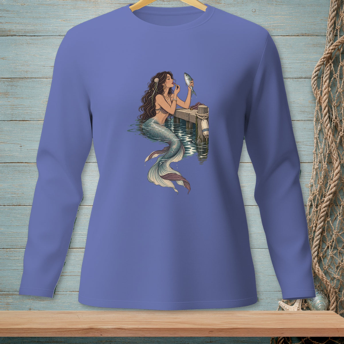 Mermaid applying makeup to a fish on a dock.
