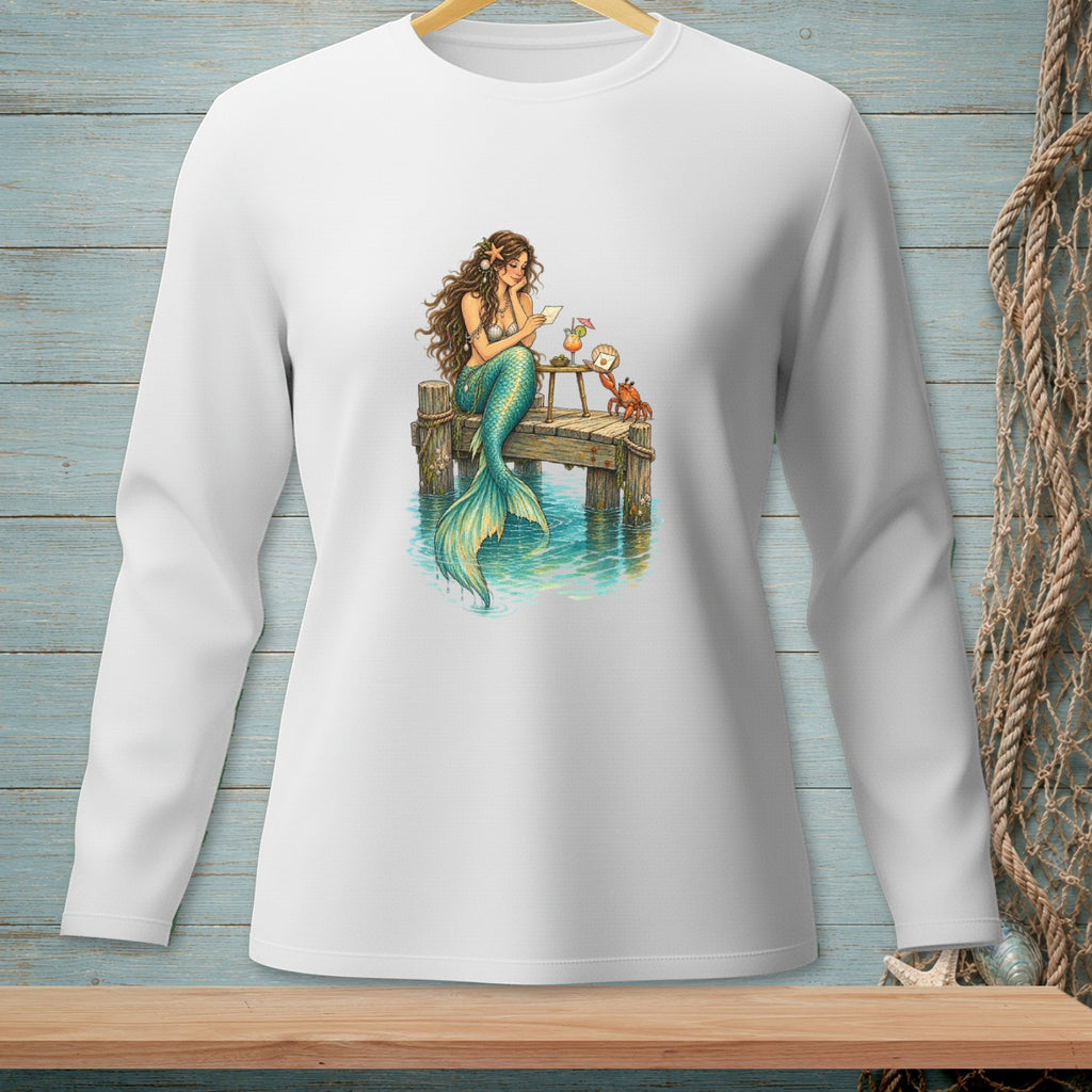 Mermaid reading a letter on a pier with a crab and drink.