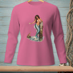 Pink long-sleeve shirt with a mermaid holding a drink by a dock.