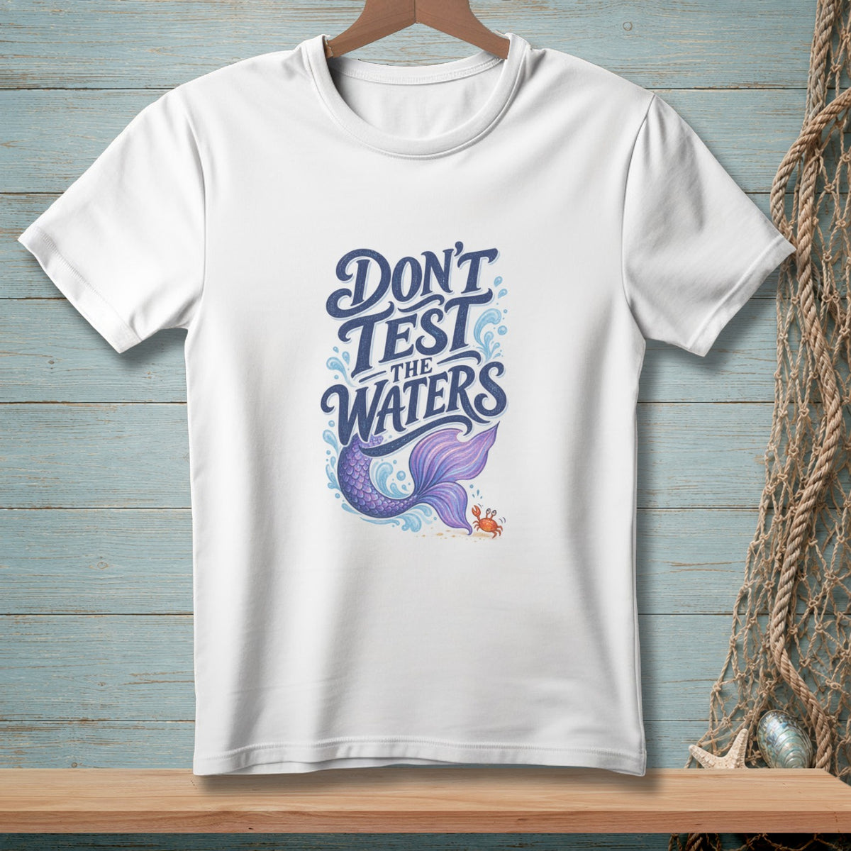 White t-shirt with purple mermaid tail and "Don't Test the Waters" text.