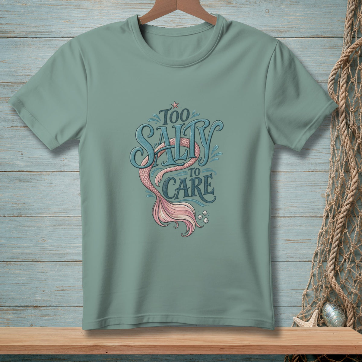 T-shirt with mermaid tail graphic and text "Too Salty To Care".