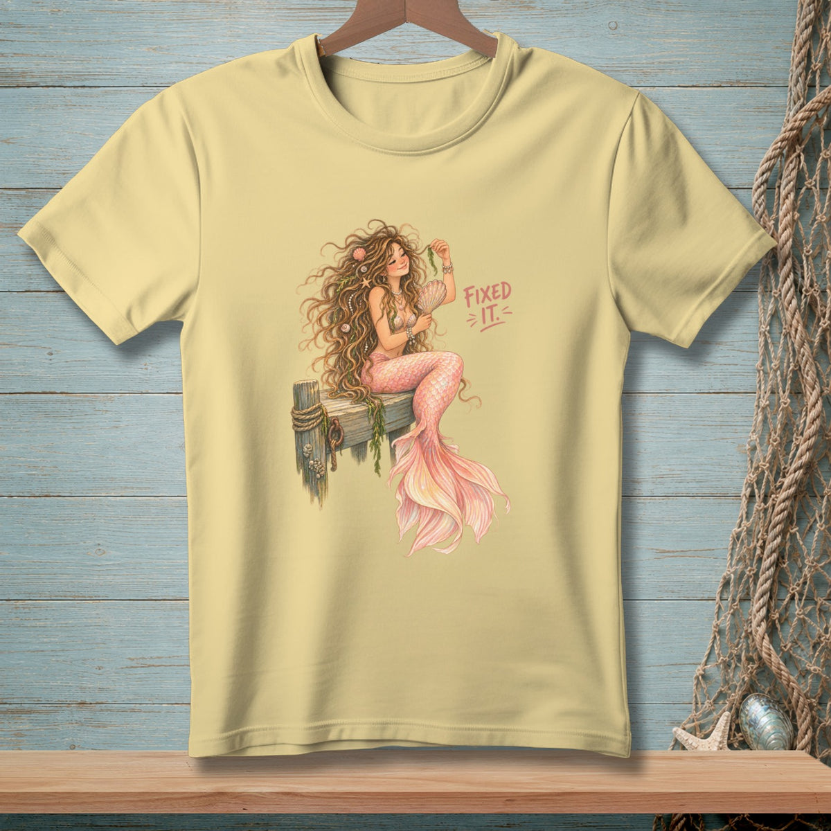 Yellow t-shirt with a watercolor illustration of a mermaid and "Fixed It" text.