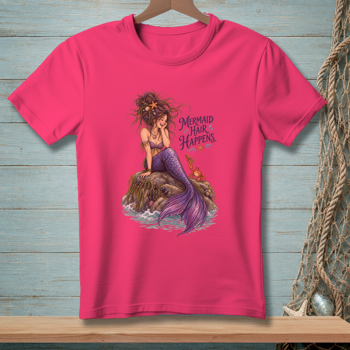 Pink t-shirt with a mermaid illustration and the text "Mermaid Hair Happens."