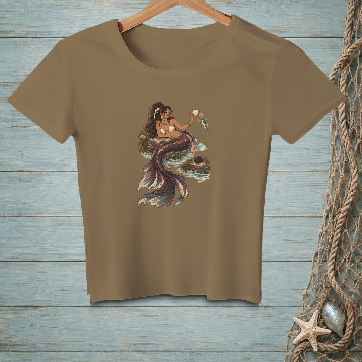 Illustration of a mermaid sitting on rocks with a seashell and a small fish.
