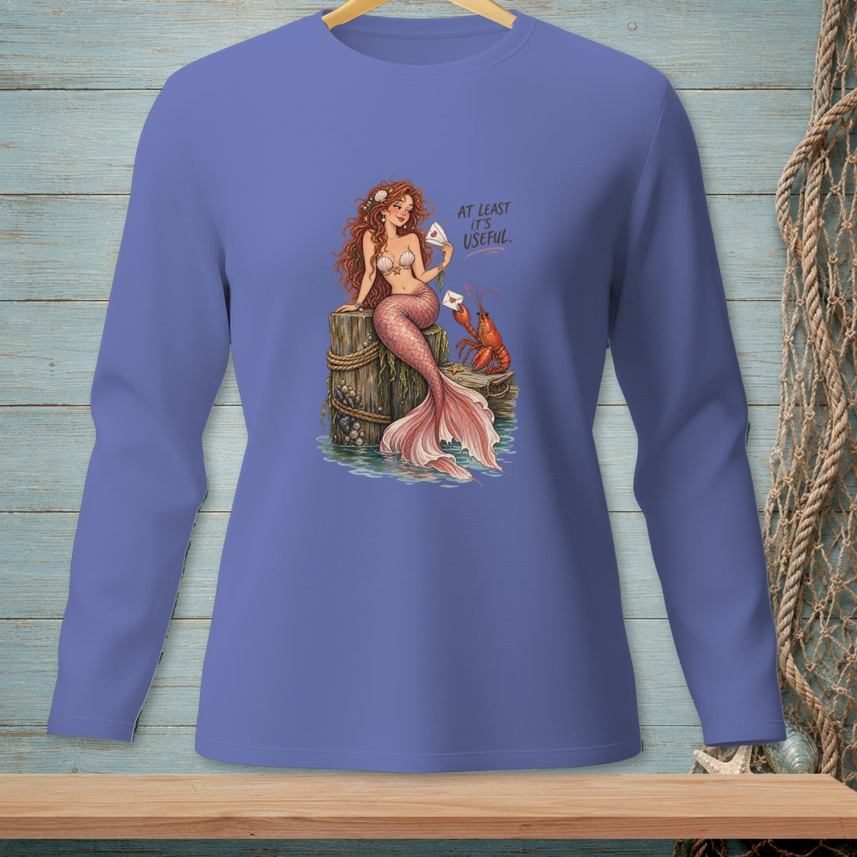 Mermaid and lobster on a wooden post with text "AT LEAST IT'S USEFUL".