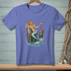 Mermaid with cocktail and crab on pilings in ocean water graphic on purple t-shirt.