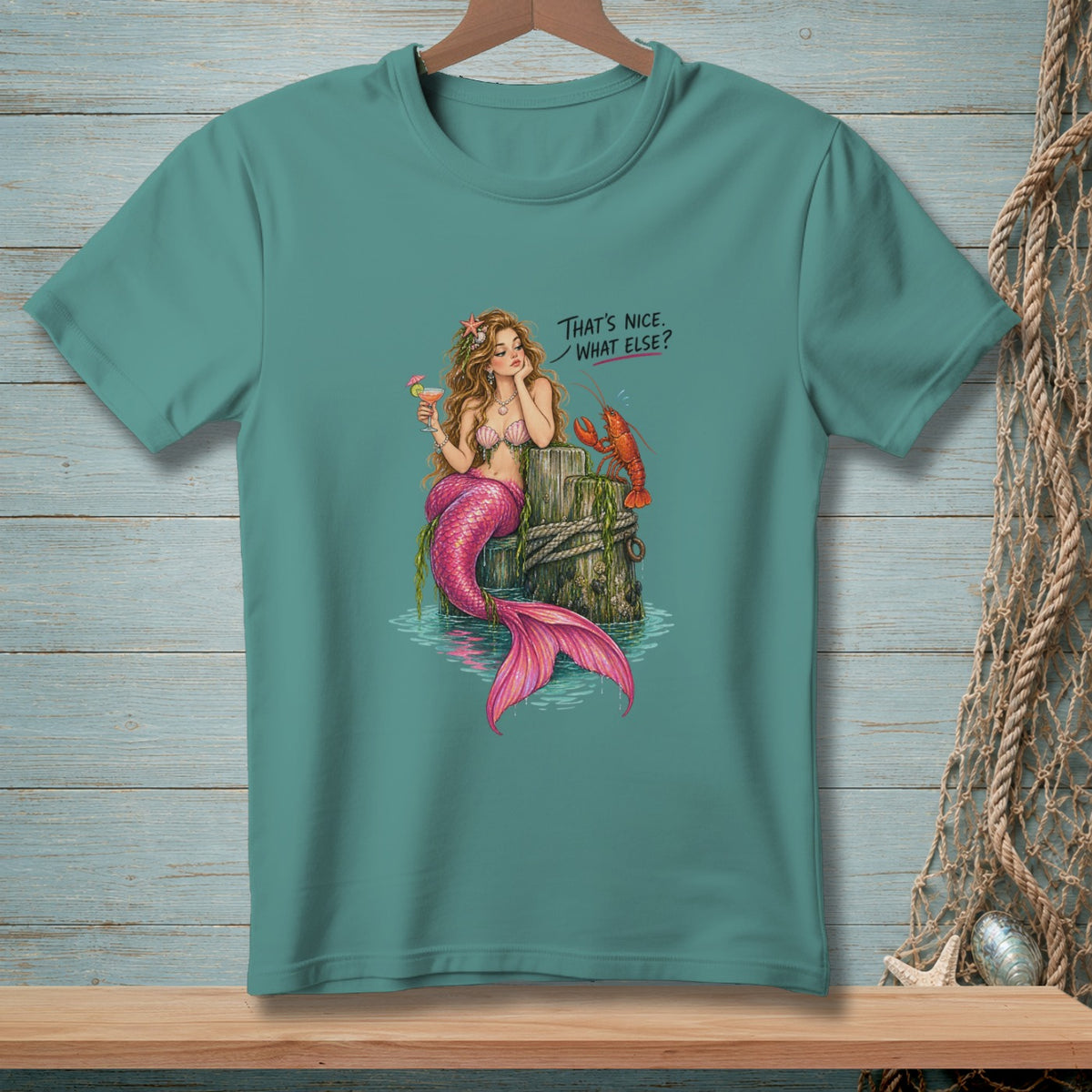 Mermaid with pink tail and drink, next to lobster, with text "That's nice. What else?".