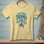 Pale yellow t-shirt with "Keep Your Drama Above Sea Level" text and mermaid tail graphic.