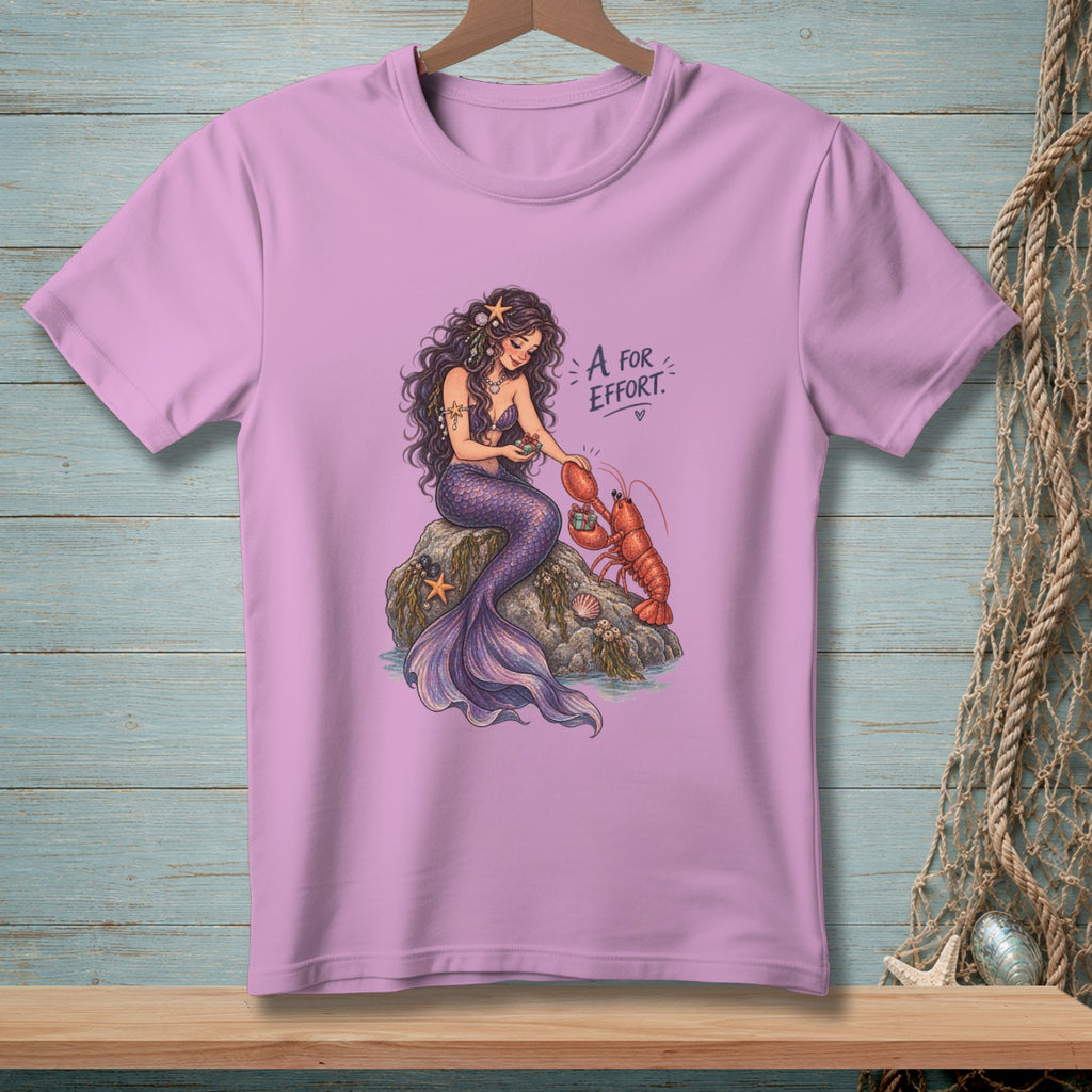 Mermaid with lobster on rock, text "A for effort."