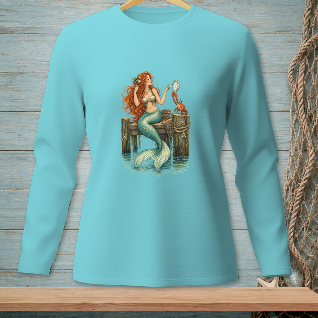 Mermaid sitting on a pier with a crab holding a mirror.
