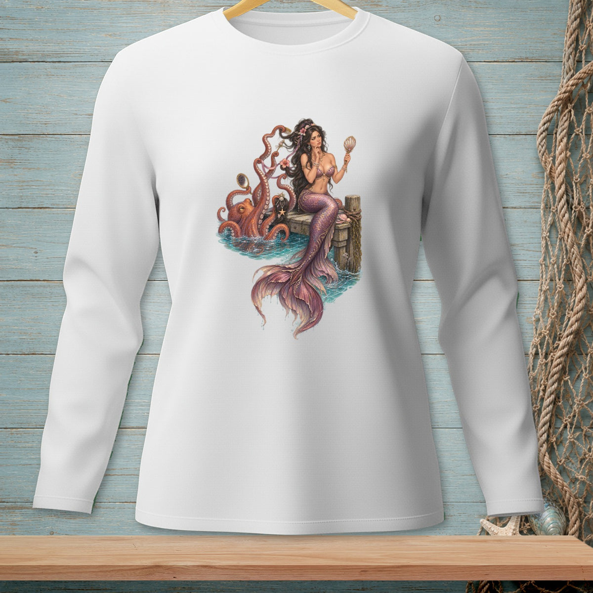Mermaid with octopus and seashell on a wooden dock, featured on white long-sleeved shirt.