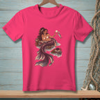 Pink t-shirt with a detailed illustration of a mermaid holding seashells and a fish.