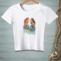 White t-shirt with illustration of two mermaids sitting on rocks.