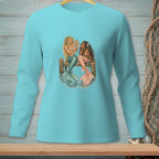 Two mermaids with colorful tails sitting on a wooden dock, one holding a mirror.
